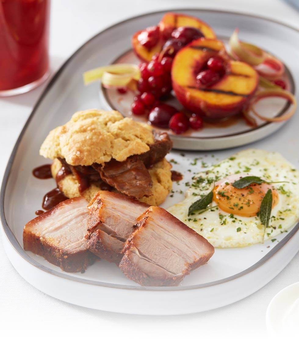 Crispy pork belly, braised pork jowl with sunny side up egg, drop biscuits and brandy braised peaches