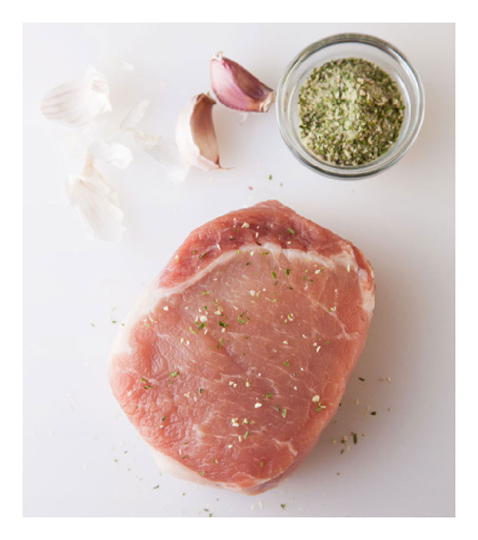 Fresh pork loin chop lightly seasoned with a dry herb mix