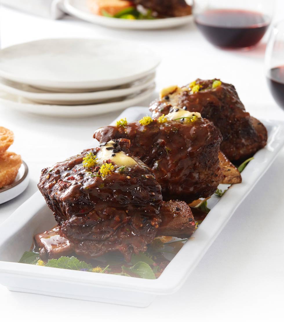Rioja braised short ribs with black garlic compound butter on crostinis