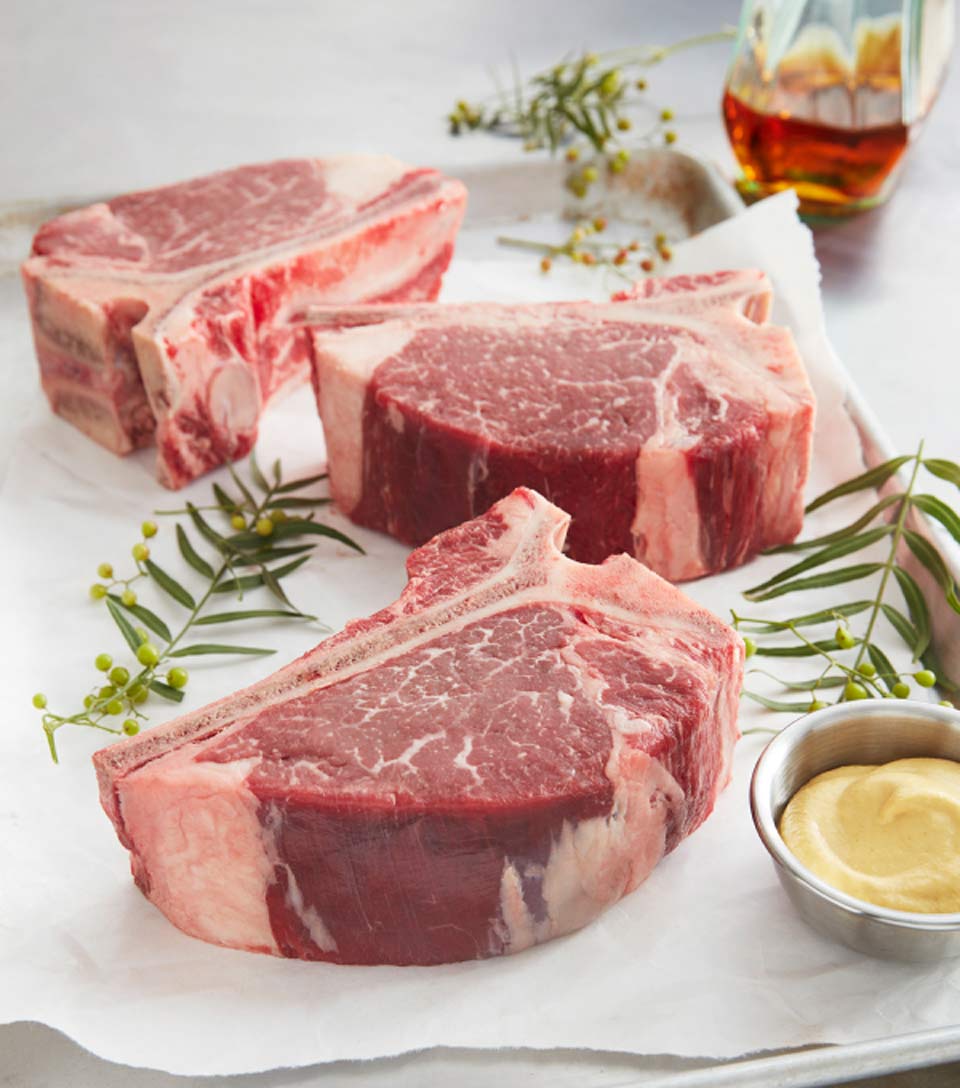 Three fresh thick-cut T-bone steaks